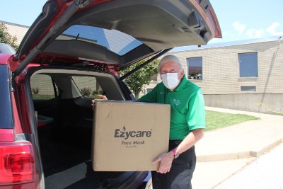 man lifting box of surgical masks