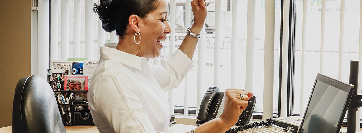 Shelan Jackson celebrating good news at her computer