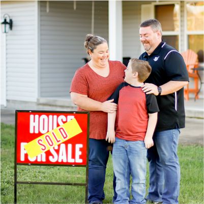 whitt family with house sold sign