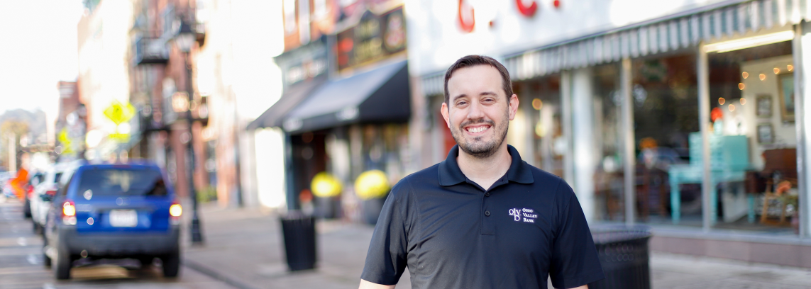 tony staley standing in front of downtown shops