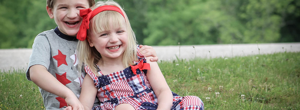 A little boy and girl sitting together laughing