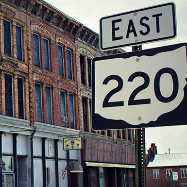 Old downtown building and a sign for Highway 220 East