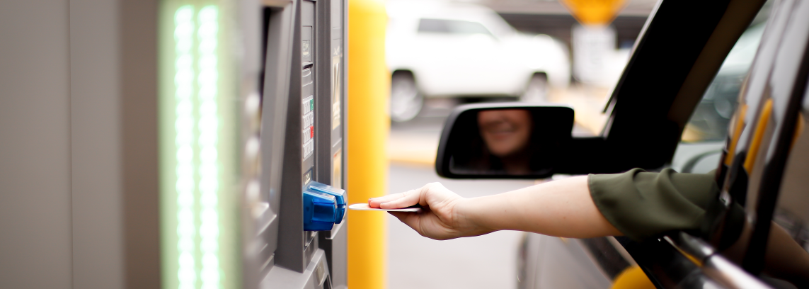 person inserting bank card into ATM